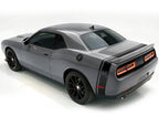 Grey Dodge Challenger with a black side & trunk stripe, shown from a rear angle.