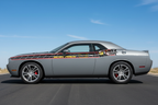 Gunmetal-gray Dodge Challenger with SCATPACK side-stripe graphics on a sunny outdoor road